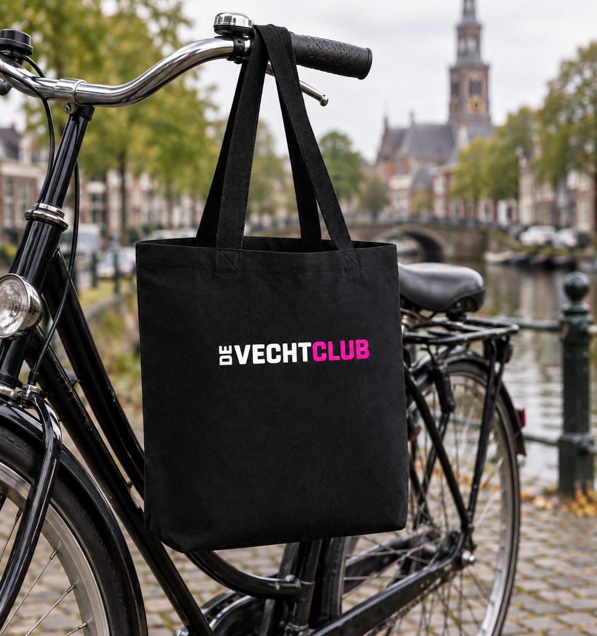 The black De Vechtclub bag on the handlebars of a bike in downtown Weesp